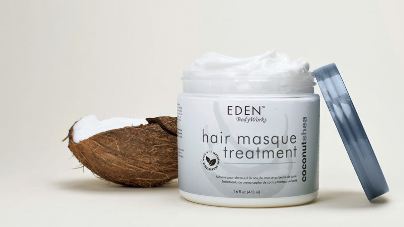 Eden BodyWorks hair masque treatment jar with a coconut on a light background